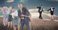 Business people walking on rope while colleagues pulling it on boardwalk Royalty Free Stock Photo