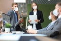 Business people wear preventive masks during epidemy in office. Royalty Free Stock Photo