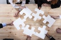 Business people work together to build a puzzle. Concept of teamwork, partnership, integration and startup Royalty Free Stock Photo