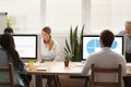 Business people working on computers sharing office desk in cowo Royalty Free Stock Photo