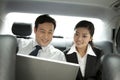 Business people working with laptop in the car Royalty Free Stock Photo