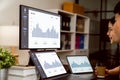 Business people working on laptops and show statistics graphs with the computer screens and tablet on the desk.