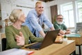 Business people, young guy and senior man and woman working together on project, having online meeting with colleagues Royalty Free Stock Photo