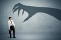 Business person afraid of a big monster claw shadow concept Royalty Free Stock Photo