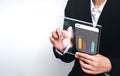 Business person analyst using a futuristic transparent tablet to analyze growth charts and data visualization, representing Royalty Free Stock Photo