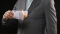 Business person burning five hundred euro bill, money wasting bankruptcy concept