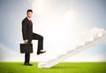 Business person climbing up on white staircase in nature Royalty Free Stock Photo