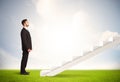 Business person climbing up on white staircase in nature Royalty Free Stock Photo