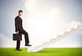 Business person climbing up on white staircase in nature Royalty Free Stock Photo