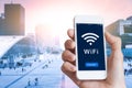 Business person connecting to WiFi hotspot on smartphone screen, city Royalty Free Stock Photo