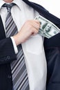 Business person, hands and money bribe in pocket for fraud, scam or secret on a white studio background. Closeup of Royalty Free Stock Photo