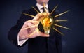 Business person holding an electric light bulb Royalty Free Stock Photo