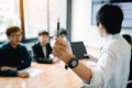 Business person holding pen and teaching with staff meeting in boardroom Royalty Free Stock Photo