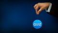 Business person holding quiz text with circle shape sign on blue background concept. Royalty Free Stock Photo