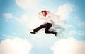 Business person jumping over clouds in the sky