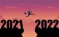 A business person jumping to the new year 2022