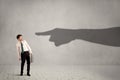 Business person looking at huge shadow hand pointing at him concept Royalty Free Stock Photo
