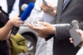 Business person or politician talking with journalists and reporters at news conference