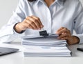 Business Person Stamping Documents in Office Setting Royalty Free Stock Photo