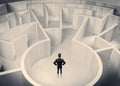 Business person standing in maze center Royalty Free Stock Photo