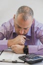 Business person thinking hard about tax. Taxation concept. Photo Of Young Depressed Businessman Sitting In Office