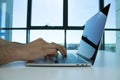 Business person using a laptop on a white table. Office located in a skyscraper