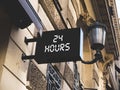 Business place signage hanging banner. Business owner puts an open sign for 24 hours.