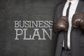 Business plan on blackboard with businessman Royalty Free Stock Photo