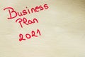 Business plan 2021 handwriting text close up isolated on yellow paper with copy space