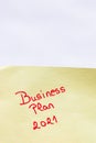 Business plan 2021 handwriting text close up isolated on yellow paper with copy space