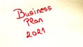 Business plan 2021 handwriting text close up isolated on yellow paper with copy space