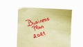 Business plan 2021 handwriting text close up isolated on yellow paper with copy space