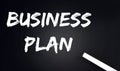 BUSINESS PLAN Text on Black Chalkboard with a piece of chalk Royalty Free Stock Photo