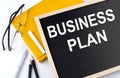 Business Plan text on blackboard with notepad ,pe,pencil Royalty Free Stock Photo