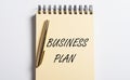 Business Plan text on notebook and pen flatly on table Royalty Free Stock Photo