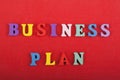 BUSINESS PLAN word on red background composed from colorful abc alphabet block wooden letters, copy space for ad text. Learning Royalty Free Stock Photo