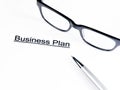 Business plan words near glasses and pen, business concept