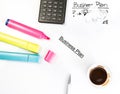 Business plan words near highlighters, calculator and cup of coffee, business concept Royalty Free Stock Photo