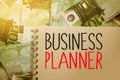 Business Planner words on copybook on 100 Euro bills. Strategical Concept