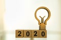 2020 Business, Planning and Idea Concept. Close up of wooden number blocks with wood light bulb icon diecut with copy space