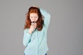 Business portrait of beautiful young woman with red curly hair and blue eyes against colorful background. Royalty Free Stock Photo