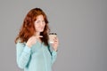 Business portrait of beautiful young woman with red curly hair and blue eyes against colorful background. Royalty Free Stock Photo