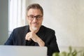 Business portrait - Businessman sitting at desk in office. Royalty Free Stock Photo