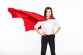 Business, power, success, achievement and people concept. Young smiling businesswoman in red superhero cape holding raised fists