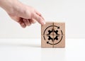 Business productivity and production process optimization. Hand places wooden cubes with cogwheel or gear symbol