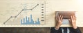 Business professional analyzing data with graphs and charts on workspace, hands on laptop, modern office setting with Royalty Free Stock Photo