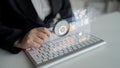 Business professional analyzing data trends through a digital dashboard while using a keyboard in a modern office Royalty Free Stock Photo