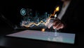 Business professional analyzing digital data charts with glowing graphs and statistics on a tablet in a dark office Royalty Free Stock Photo