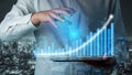 Business Professional Analyzing Digital Data with Graph and Chart for Financial Growth in Modern Urban Environment at Royalty Free Stock Photo