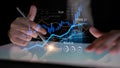 Business professional analyzing digital financial charts on tablet screen with futuristic interface and glowing graphs Royalty Free Stock Photo